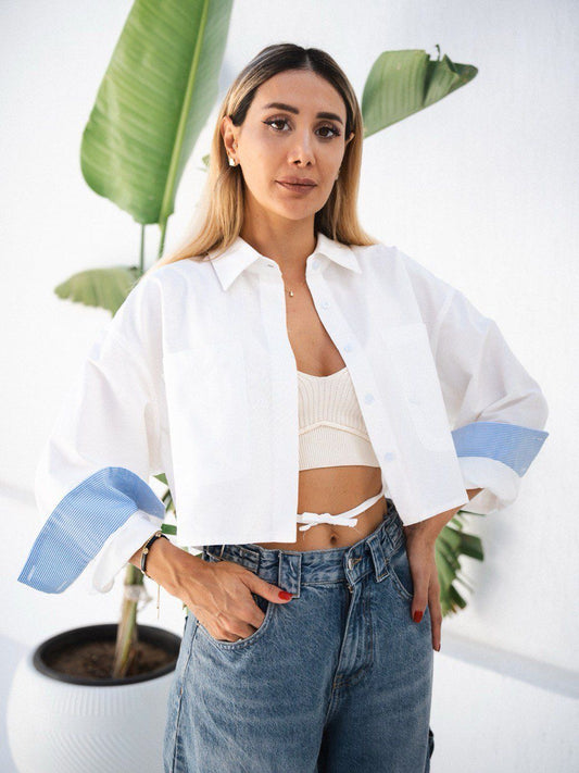 White cropped button-up shirt with blue cuff accents